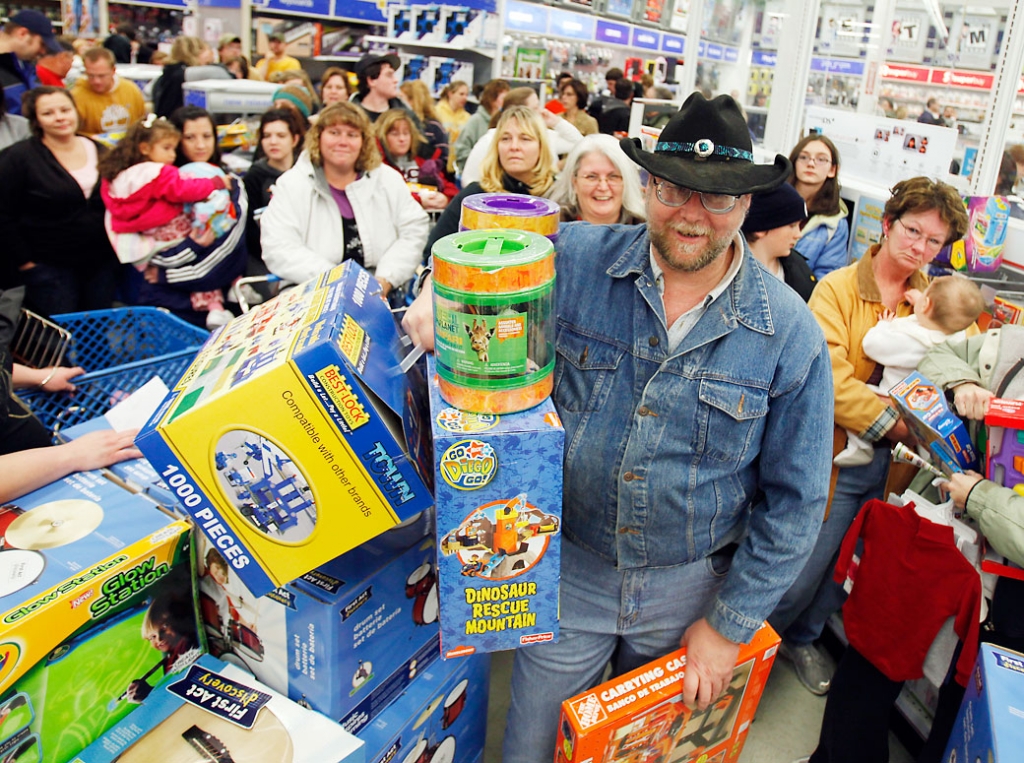 Black Friday holiday Greg Inman of Shermans Dale, Pa., waits in a checkout line with other shoppers at Toys "R" Us in Camp Hill, Pa., early Friday morning, Nov. 27, 2009. (AP Photo/Carolyn Kaster)