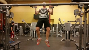 Matt Willis doing weighted pull-ups.