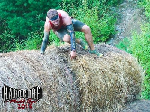Logan Nagle clearing a hay bale obstacle.